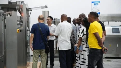 Bruce Fu is explaining the fully automatic tablet press to Kenyan customers