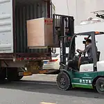 Forklift driver is loading wooden boxes carefully-Candy Packaging Machine